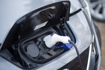 Electromobile. Charging an electric vehicle when the charger is switched on.