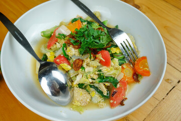 stir fry vegetable on the white plate and spoon fork