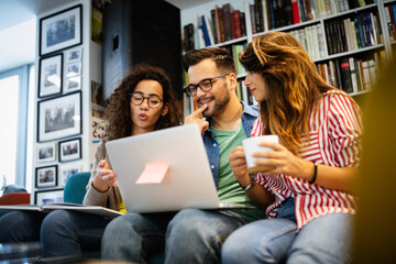 Group of college students studying in the school library.
