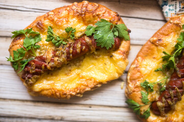 Hot pizza with sausage and cheese on wooden table. Food concept