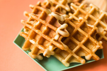 Viennese waffles on coral background