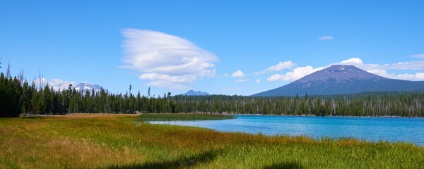 Panoramic view of the Hosmer Lake with South Sister, Broken Top, and Bachelor mountains on background in Central Oregon.