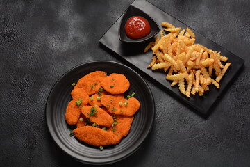 Chicken schnitzel or nuggets with chips and ketchup