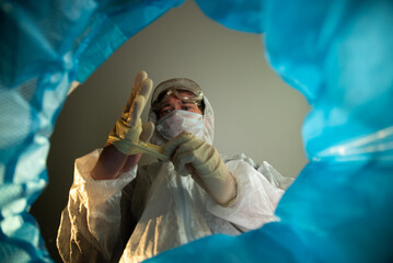 End of quarantine victory over the coronavirus. View from the trash can a man doctor removes a...
