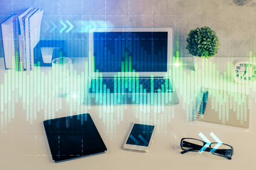 Financial chart drawing and table with computer on background. Double exposure. Concept of international markets.