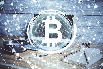 Multi exposure of blockchain and crypto economy theme hologram and table with computer background....