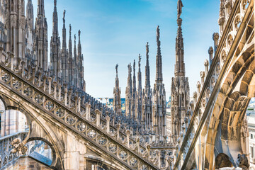 Marble statues - architecture on roof of Duomo gothic cathedral in Milan