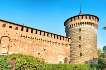 Brick wall and round tower of Sforza Castle in Milan, Italy