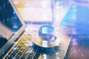 Double exposure of desktop computer and technology theme hologram. Concept of software development.
