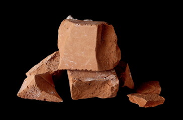 Broken brick pieces, chunks for bricklaying and construction isolated on black background