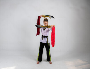 beautiful girl in a black and white kimono and with golden swords