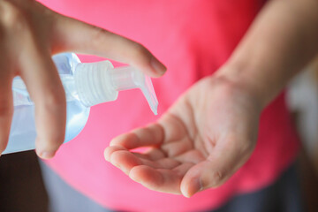 Woman using alcohol sanitizer gel rub for cleaning hand COVID-19 corona virus prevention concept