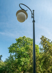 Street lamp or lamp post against blue sky.