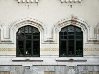 Architectural detail of an old building with twin windows, in the center of Bucharest, Romania.