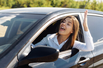 Nice business woman shouting in the car. Road agressiong concept.