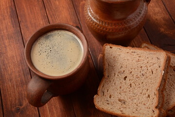 Traditional Russian or Ukrainian  Malt Beer -Kvass in  mug with rye bread on wooden table.