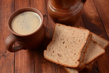 Traditional Russian or Ukrainian  Malt Beer -Kvass in  mug with rye bread on wooden table.