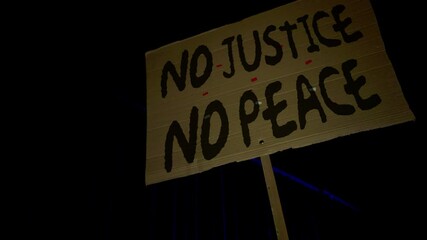 Black Lives Matter. Black Rights Protest. The crowd protests against racial inequality. Riot against police brutality and racism. Red and blue Light police car. 