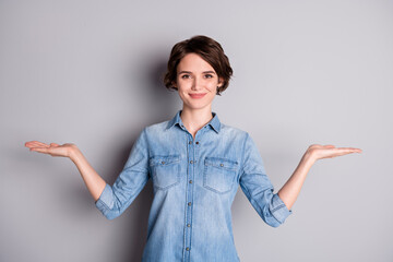 Photo of attractive lady hold open arms hands empty space showing nice offer two variants pick...