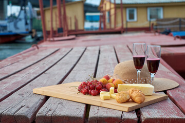 Two glasses of red wine, served outdoor with fruits