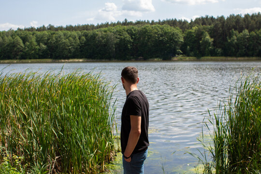 man near the lake in the forest - Powered by Adobe