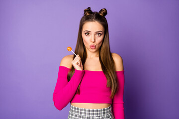 Photo of adorable lady hold sweet candy chupa chups send air kisses coquettish person wear pink off-shoulders cropped top plaid skirt isolated pastel purple color background