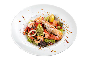 seafood salad on a white plate on a white isolated background. Shrimp, squid, pepper, lemon