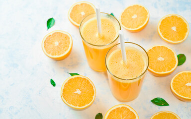 orange juice in a glass, top view, slices of oranges, straw, healthy lifestyle concept