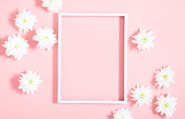 Beautiful flowers composition. Photo frame, white flowers on pastel pink background. Valentines Day, Happy Women's Day. Flat lay, top view, copy space