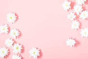 Fototapeta premium Beautiful flowers composition. White flowers on pastel pink background. Flat lay, top view, copy space