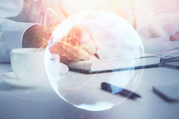Double exposure of hands and notepad with business icons.