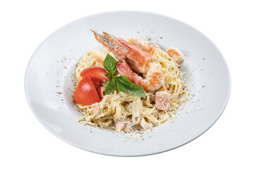 pasta with seafood on a white plate on a white isolated background. Salmon, shrimp, cheese, pasta, tomato
