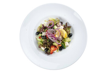 Greek salad on a white plate on a white isolated background. Cucumber, olives, peppers, oil, salad
