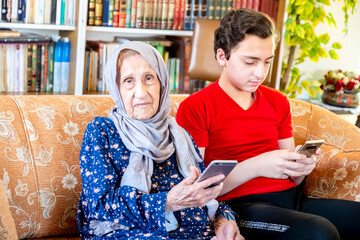 Happy arabic muslim grand mother and her son sitting together on