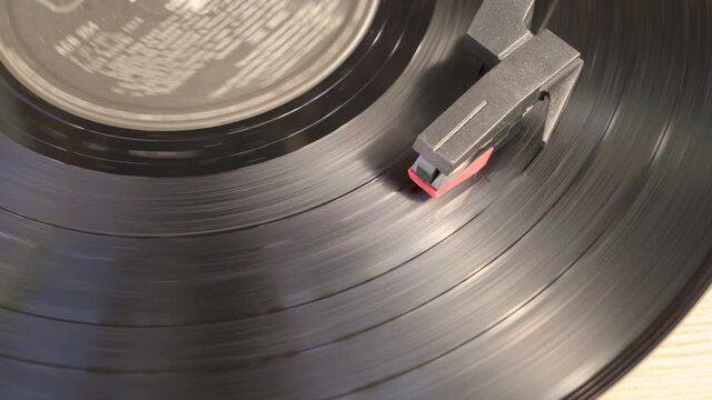 Black vinyl Record Player spinning. Playing album on a vintage turntable. Retro old school music playing device. Pro Res 4K