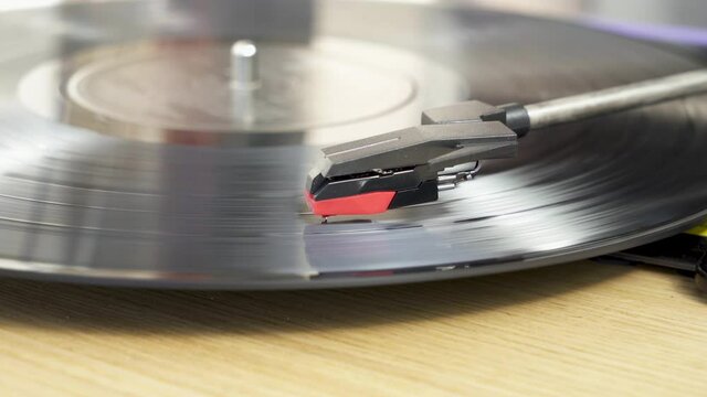 Black vinyl Record Player spinning. Playing album on a vintage turntable. Retro old school music playing device. Pro Res 4K