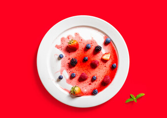Strawberries and blackberries on defrosted popsicle on white dish