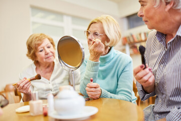 Senior women applying makeup and styling