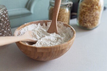 A bowl of white flour on a table. Gluten free concept. Excess weight concept.