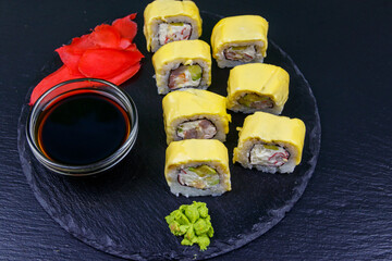 Sushi cheese rolls on a black slate