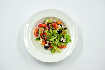 A bowl of salad on a white plate