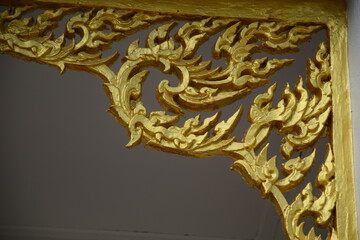 Golden painted Thai temple wall