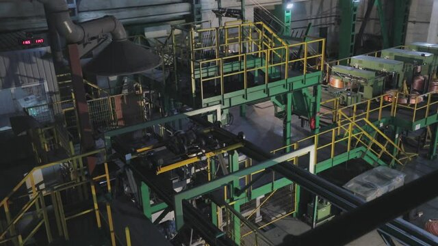 Automated copper feed line to the furnace. The melting of copper in the furnace, the process of melting copper in the furnace.