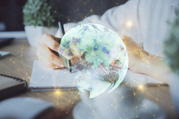 Social network theme hologram over woman's hands writing background. Concept of international people connect. Double exposure