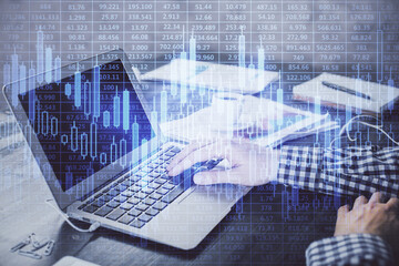 Double exposure of forex chart with man working on computer on background. Concept of market analysis.