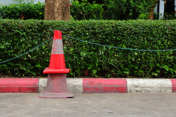 Closeup stack of two traffic cones, the smaller one with brighter color is above the larger with faded color, together we are strong concept  