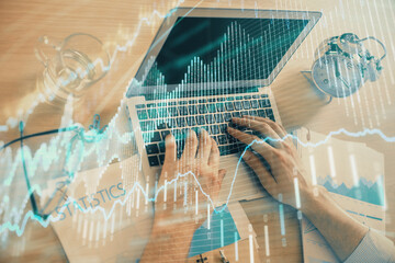 Fototapeta na wymiar Multi exposure of forex graph with man working on computer on background. Concept of market analysis.