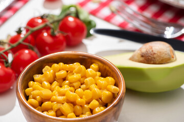 selective focus of fresh avocado, corn and cherry tomatoes