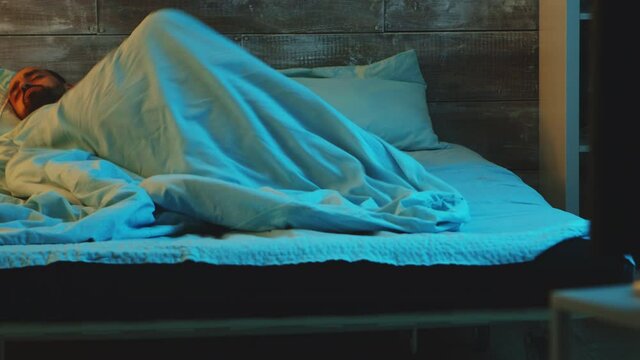 Young man suffering from anxiety and restless sleep