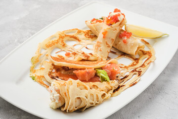 Russian pancakes with salmon and red caviar